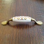 Puxador Metal e Porcelana Branca Des Dourado 96mm - C1427
