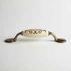 Puxador Metal e Porcelana Marfim Des Dourado 96mm - C1574